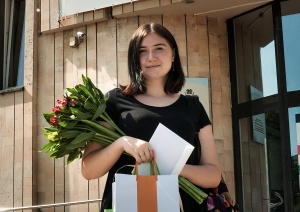 Sieviete ar ziediem un balvu